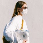 woman-in-mask-holding-toilet-paper